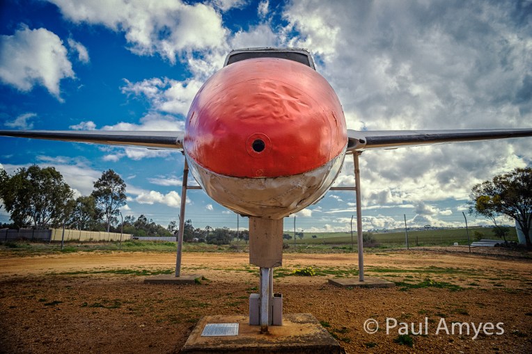 This lens encourages you to look for unusual points of view. A Vampire jet on the Beverley-York Road advertises the Beverley Aeronautical Museum.