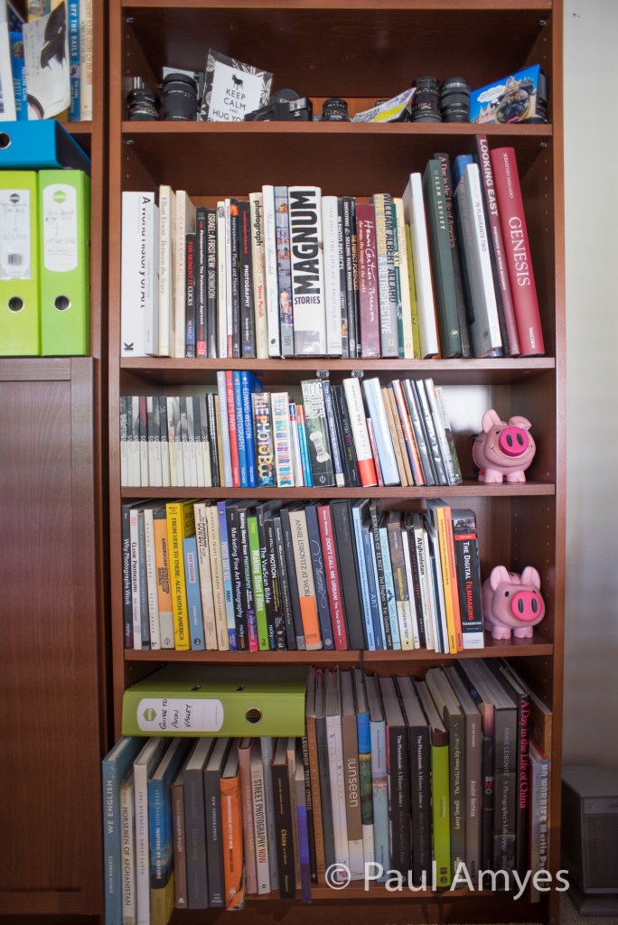 The book shelf optical test. The camera is mounted on a tripod so as to get the whole shelf in the frame without causing loss of the parallel vertical lines.